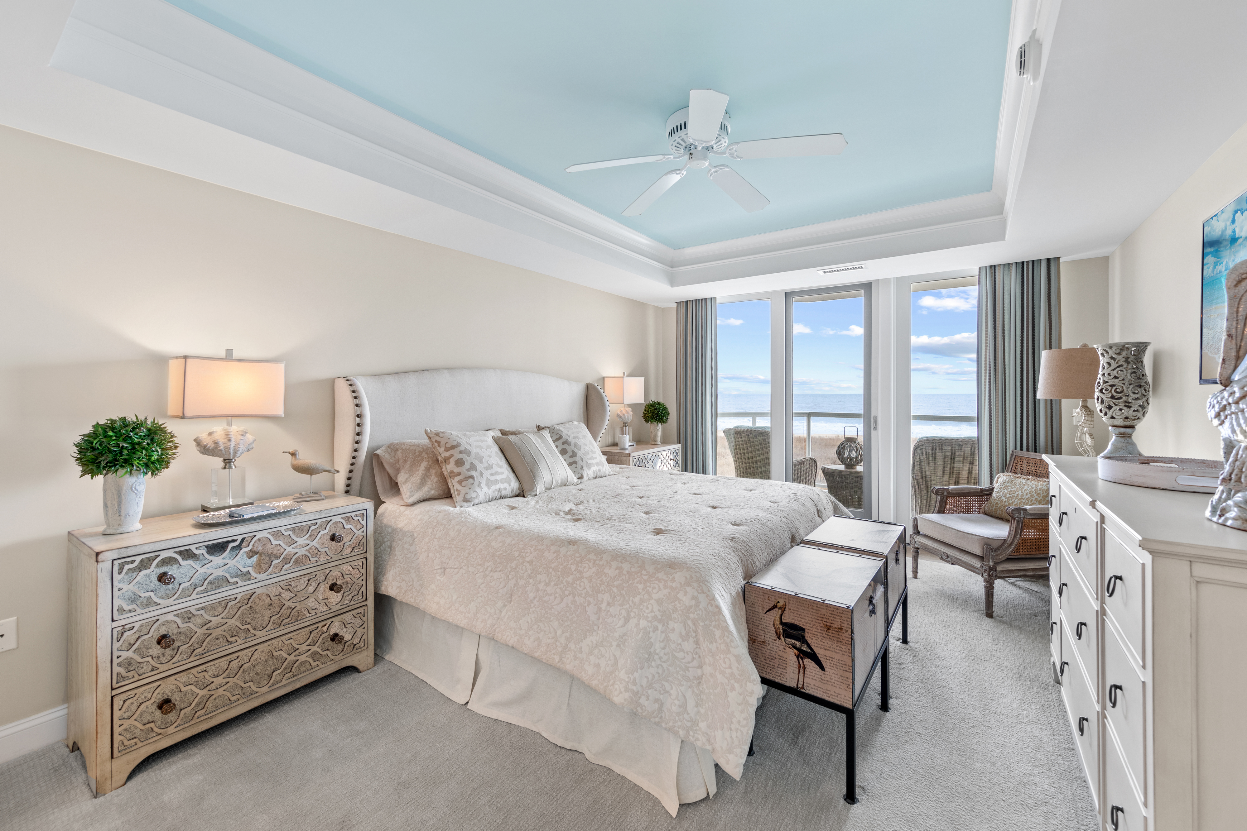 The gorgeous Primary Bedroom is serene in hues of sand and sea.