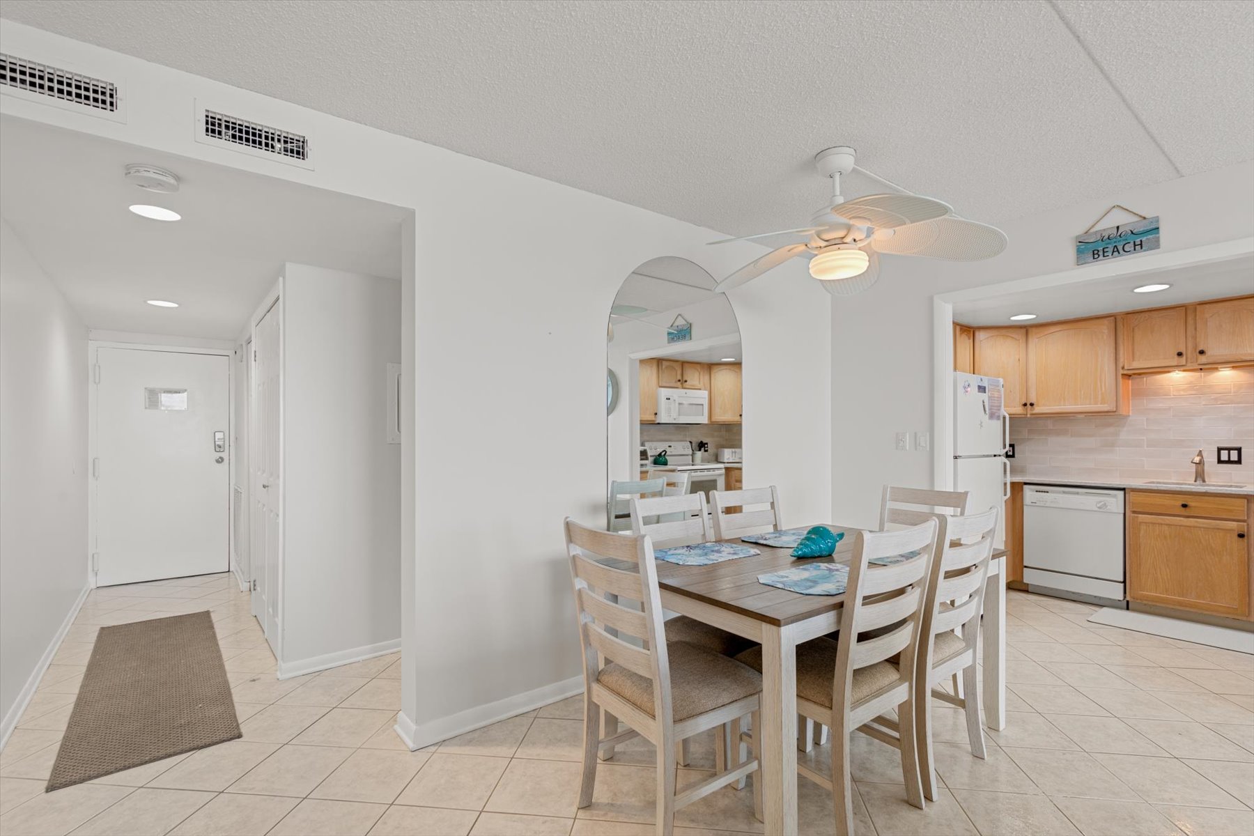 The dining table, seating 6, offers plenty of space for the whole family to enjoy a warm, home-cooked meal.
