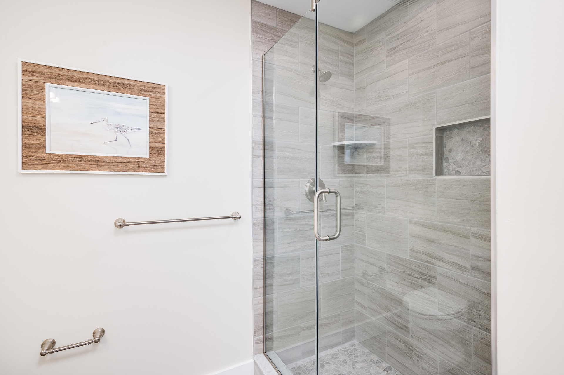 Freshen up from the days of fun in the sun in this Custom tile, Walk-In Shower!