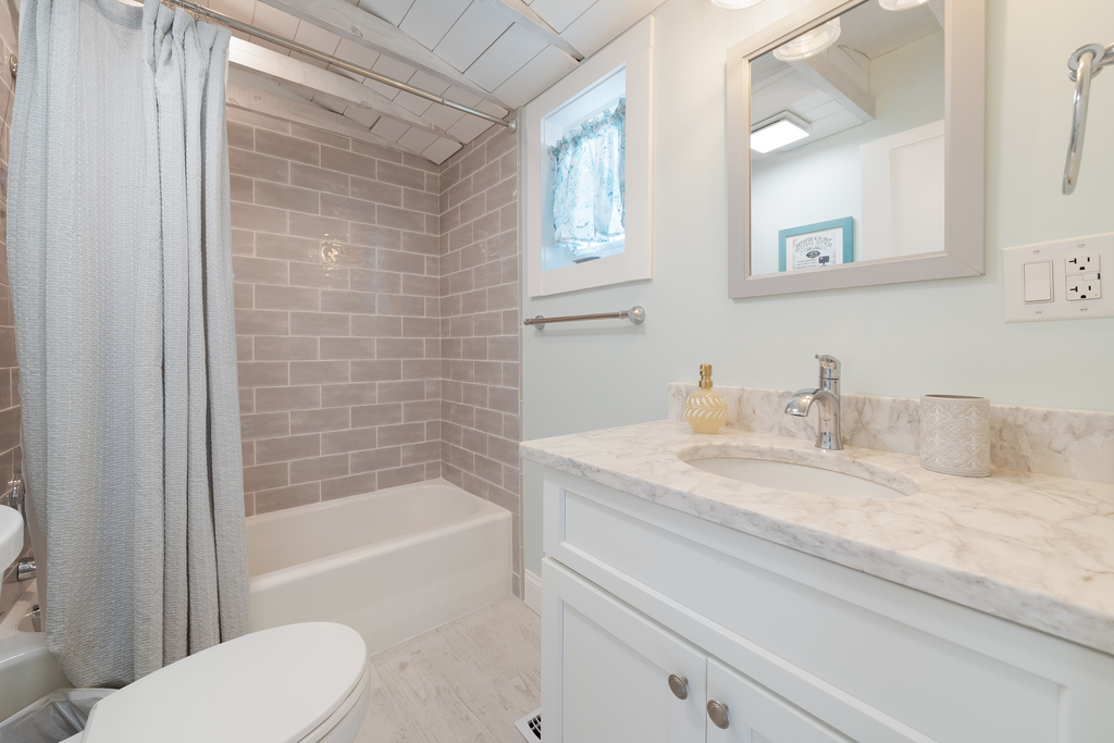 There's a Brand New Full Bath with a Custom Tile Tub/Shower Combo just off the Kitchen.