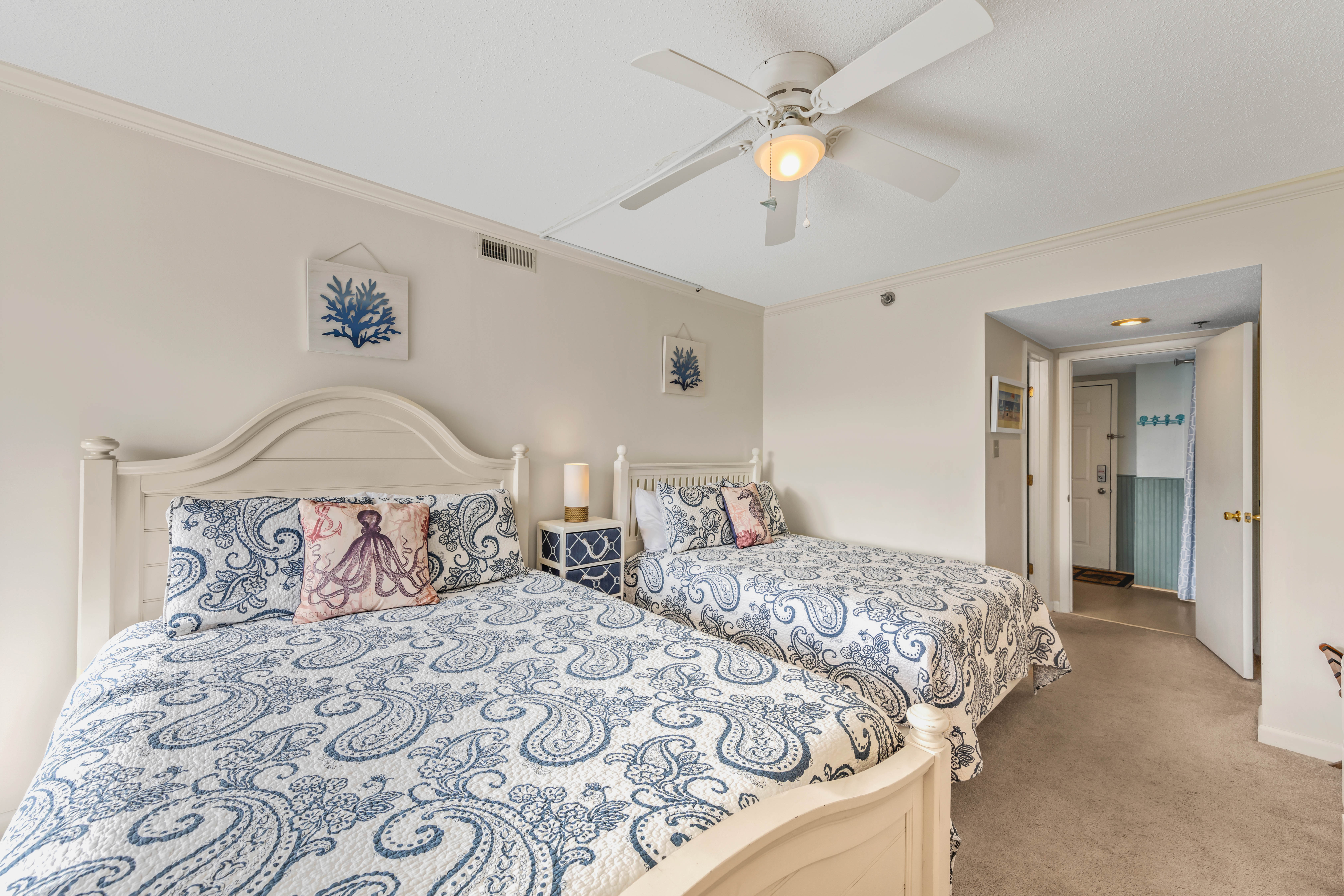Bedroom 2 features 2 Plush Queen beds.