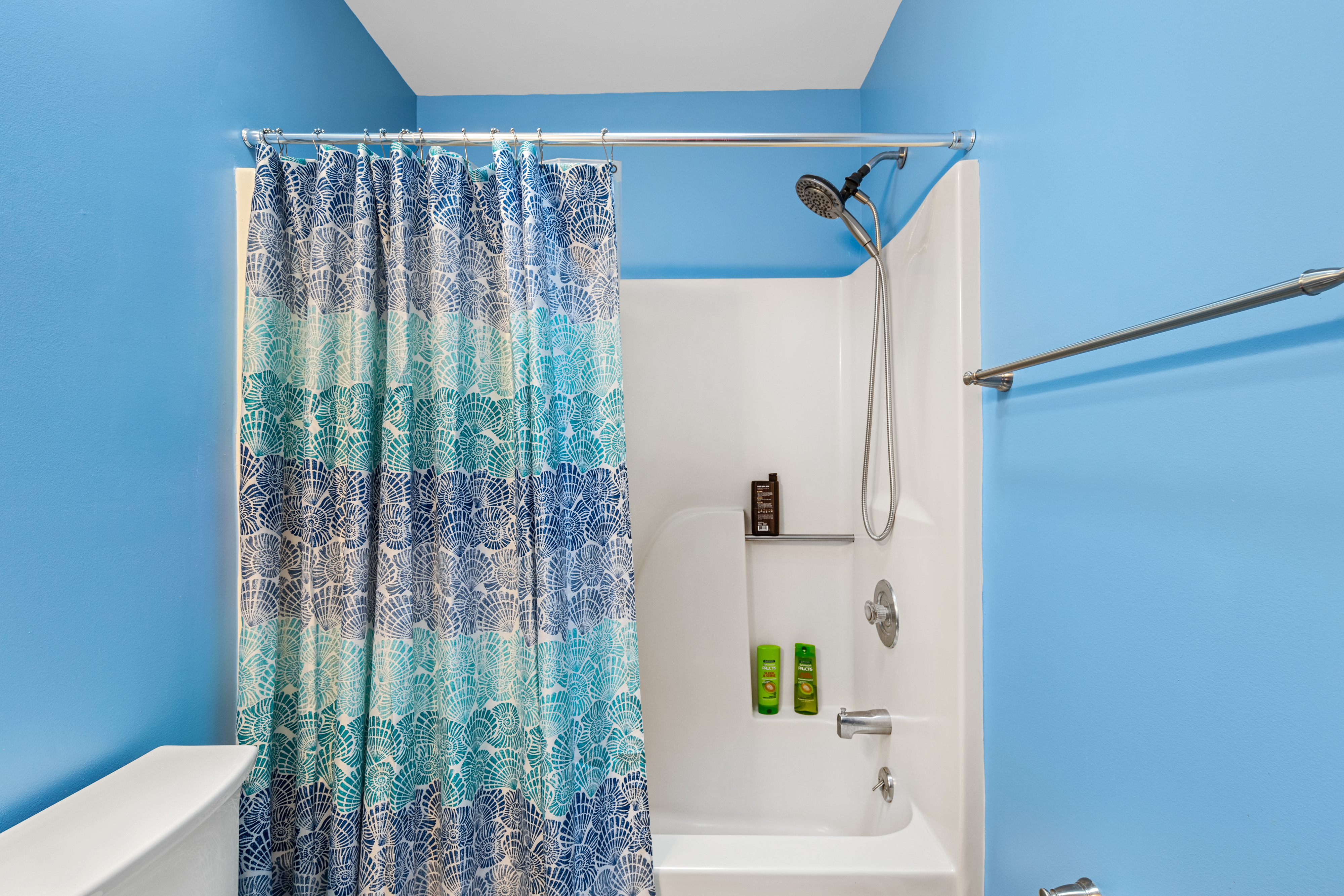 Rinse off the Hot Sun in the Shower/Tub Combo in this Shared Full Bath.