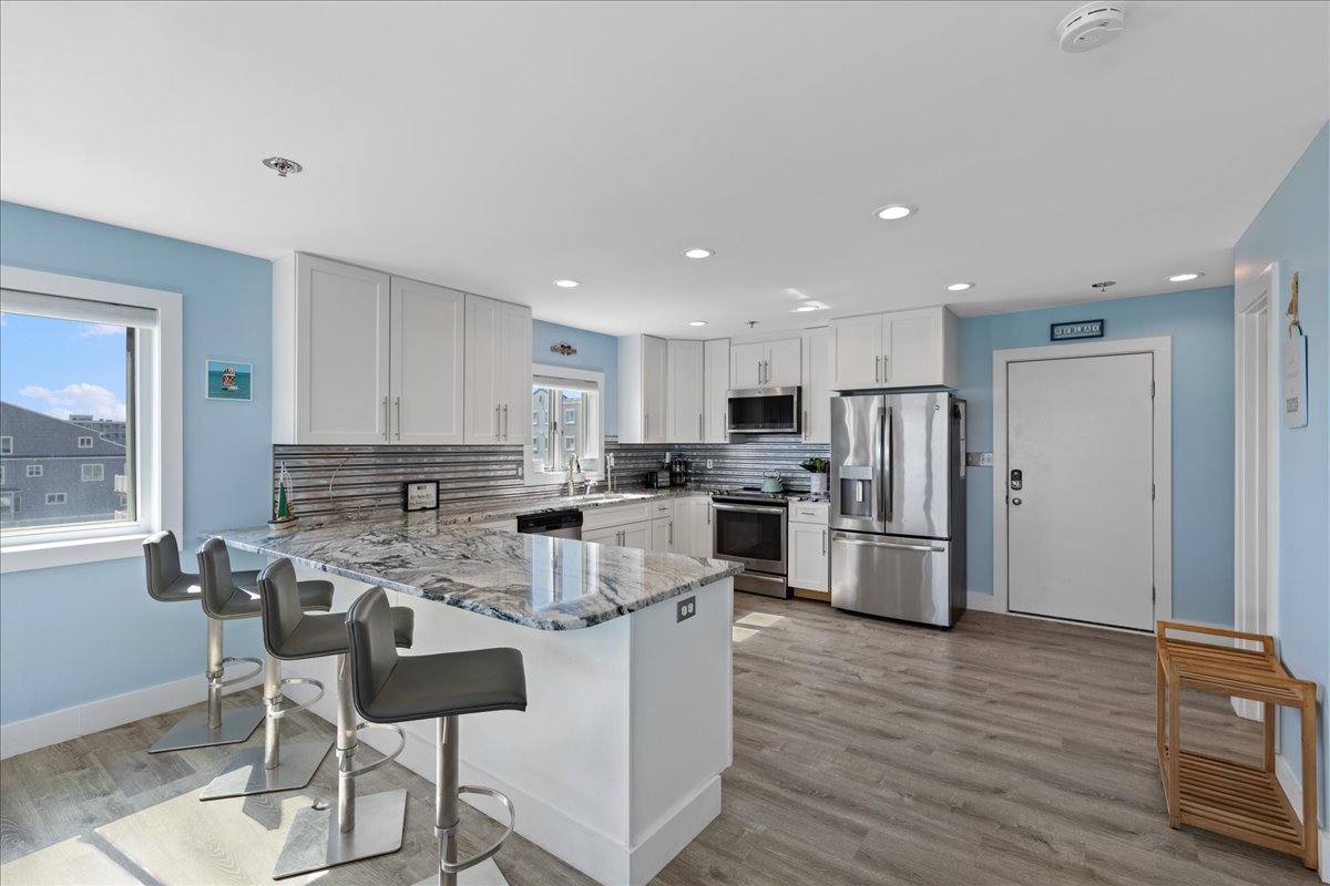 Bright and refreshing kitchen with all new stainless steel appliances and marble countertops.