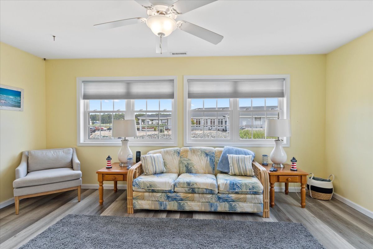 A sunny, yellow Sunroom lines the back of the house with great Views of the Canal and the Chincoteague Bay.