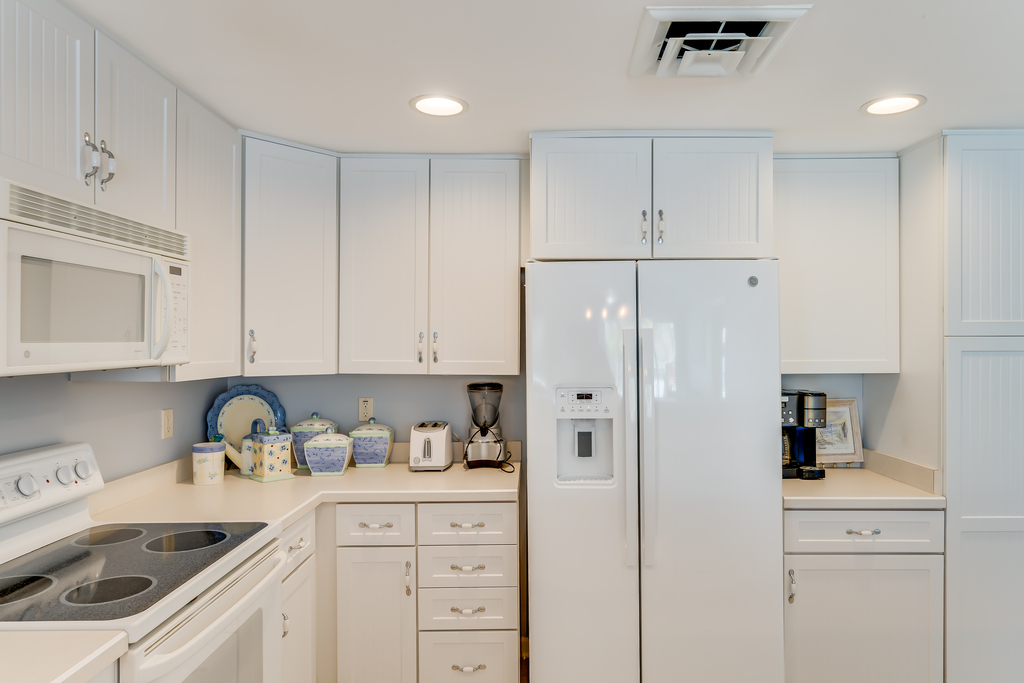 Beachy white bead board and gleaming Corian Counters.