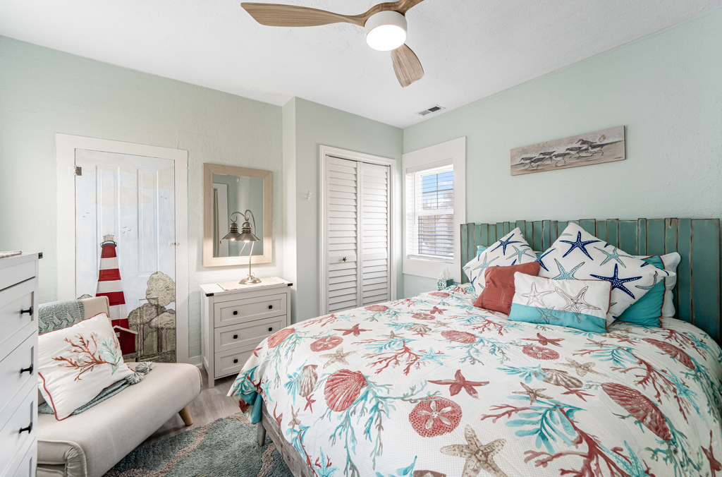 Wandering upstairs, Bedroom 1 has a comfy Queen Bed and gorgeous coastal colors.