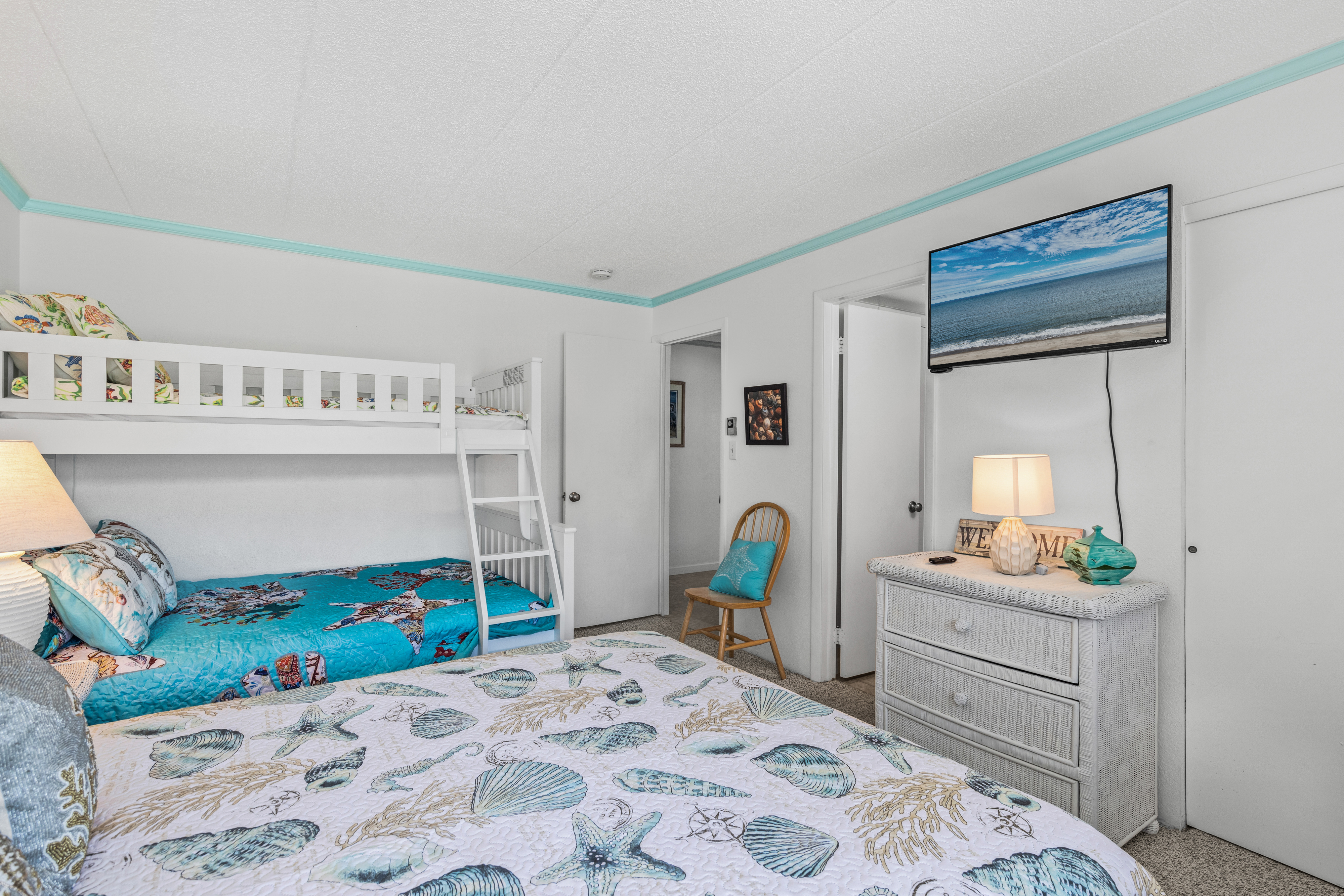 The Fresh bright decor and cozy bedding of this room with have you loved ones sleeping like a baby.