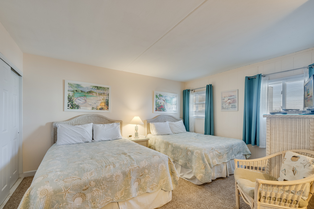 The bedroom offers 2 Comfy Queen Beds.