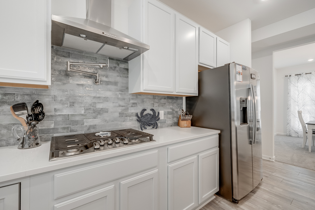 Stainless Appliances, Quartz Countertops, and oh, that backsplash!
