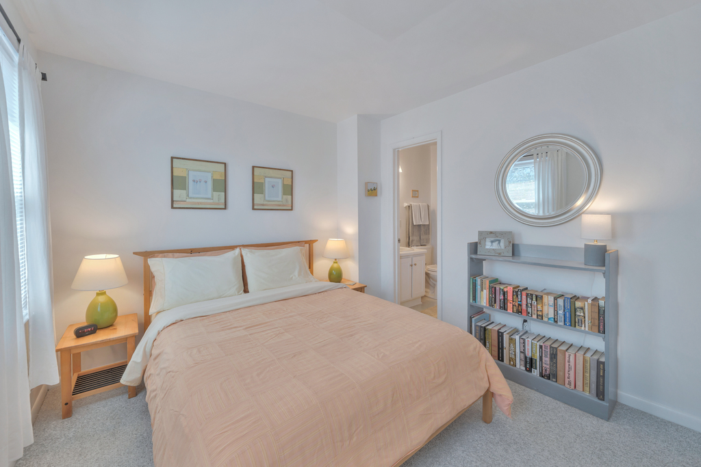 Bedroom 2 has a comfy Queen Bed and is dressed in coastal coral.