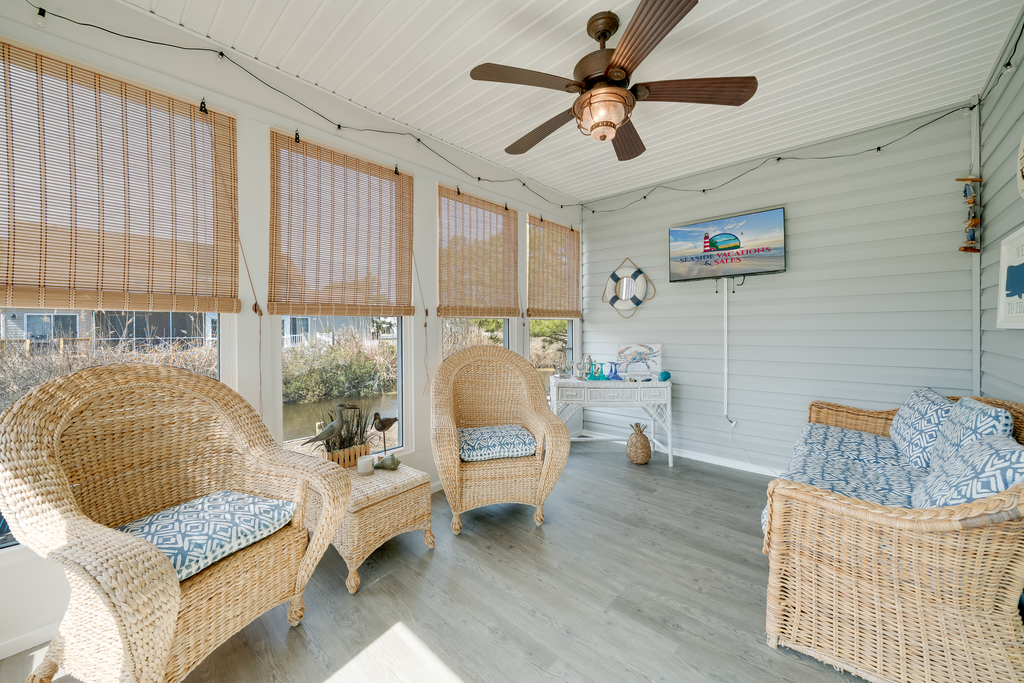Just off the Living Area, the Sunroom has lovely Water Views, comfy furnishings, and another Smart TV.