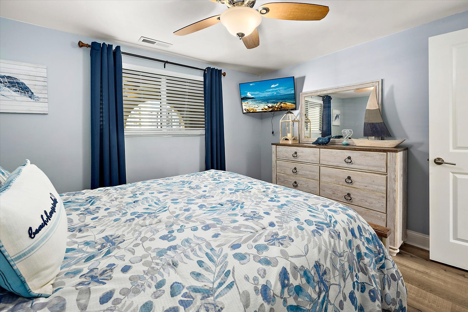Catch up on your favorite shows from this comfortable bed with the wall-mounted flatscreen TV and plenty of storage space in the dresser.