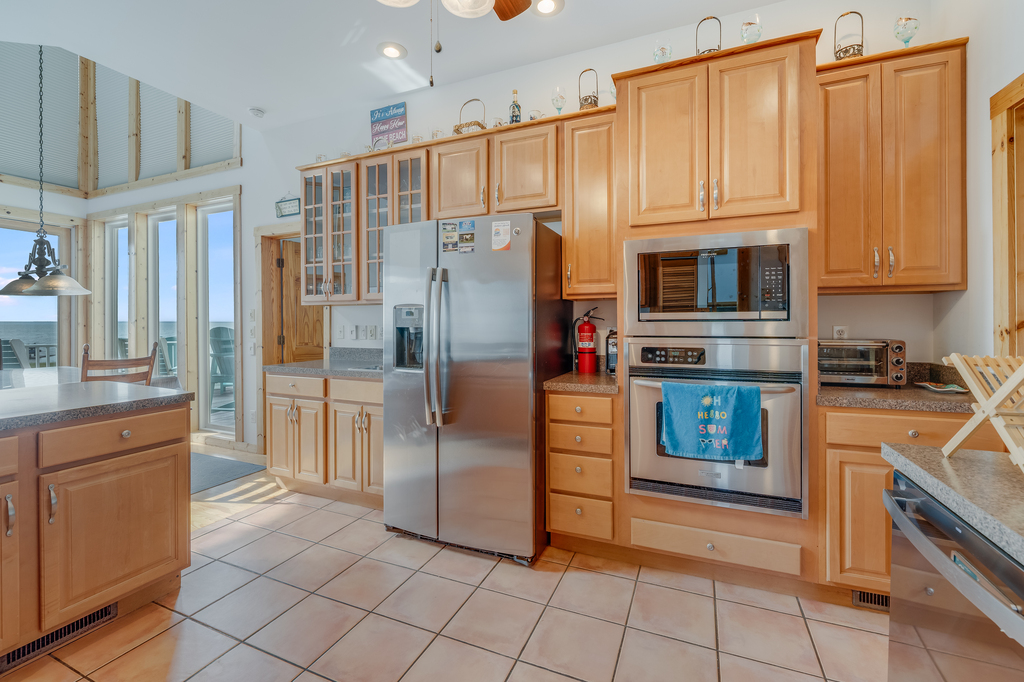 Stainless Appliances and warm Wood Cabinetry are so welcoming.