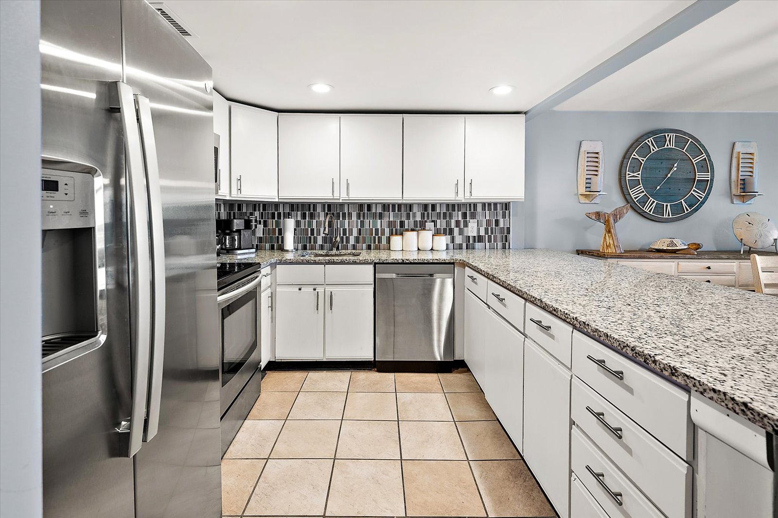 This crisp, modern kitchen features seamless cabinetry and expansive counter space, making meal prep a breeze.