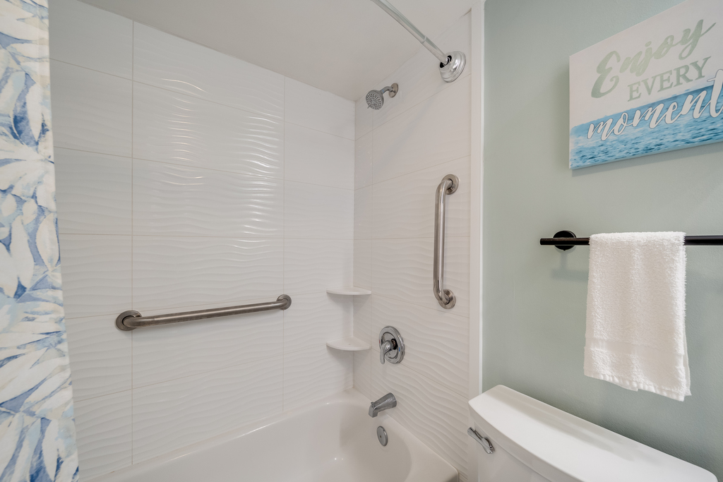 The clean tub and shower combo features convenient handrails for added safety and comfort.