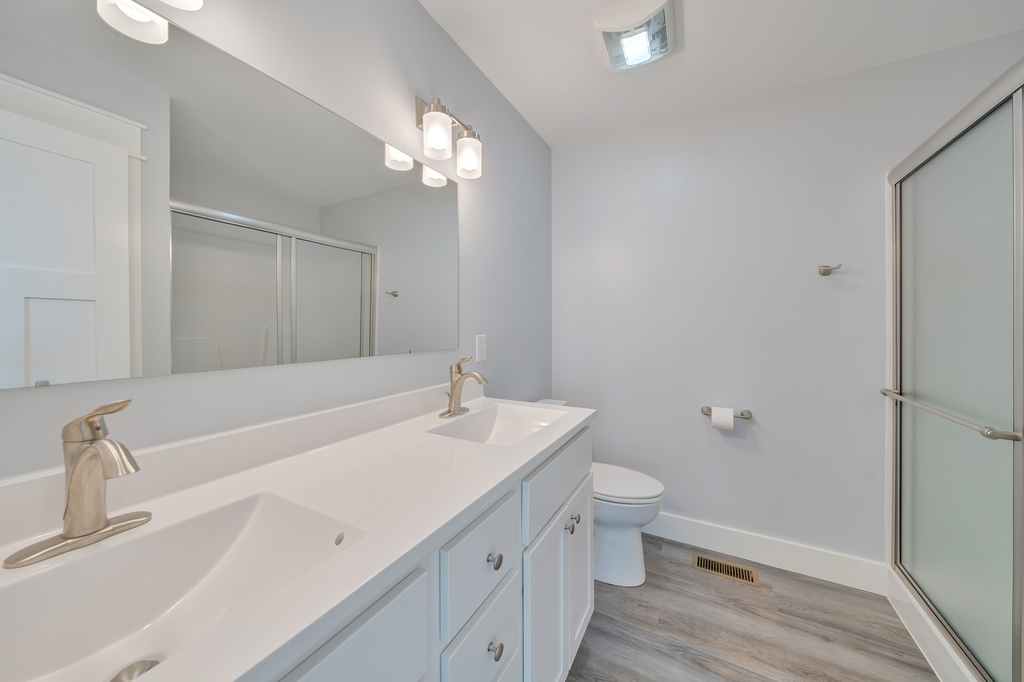 Attached Full Bath with Double Vanity and Custom Walk-in Shower.