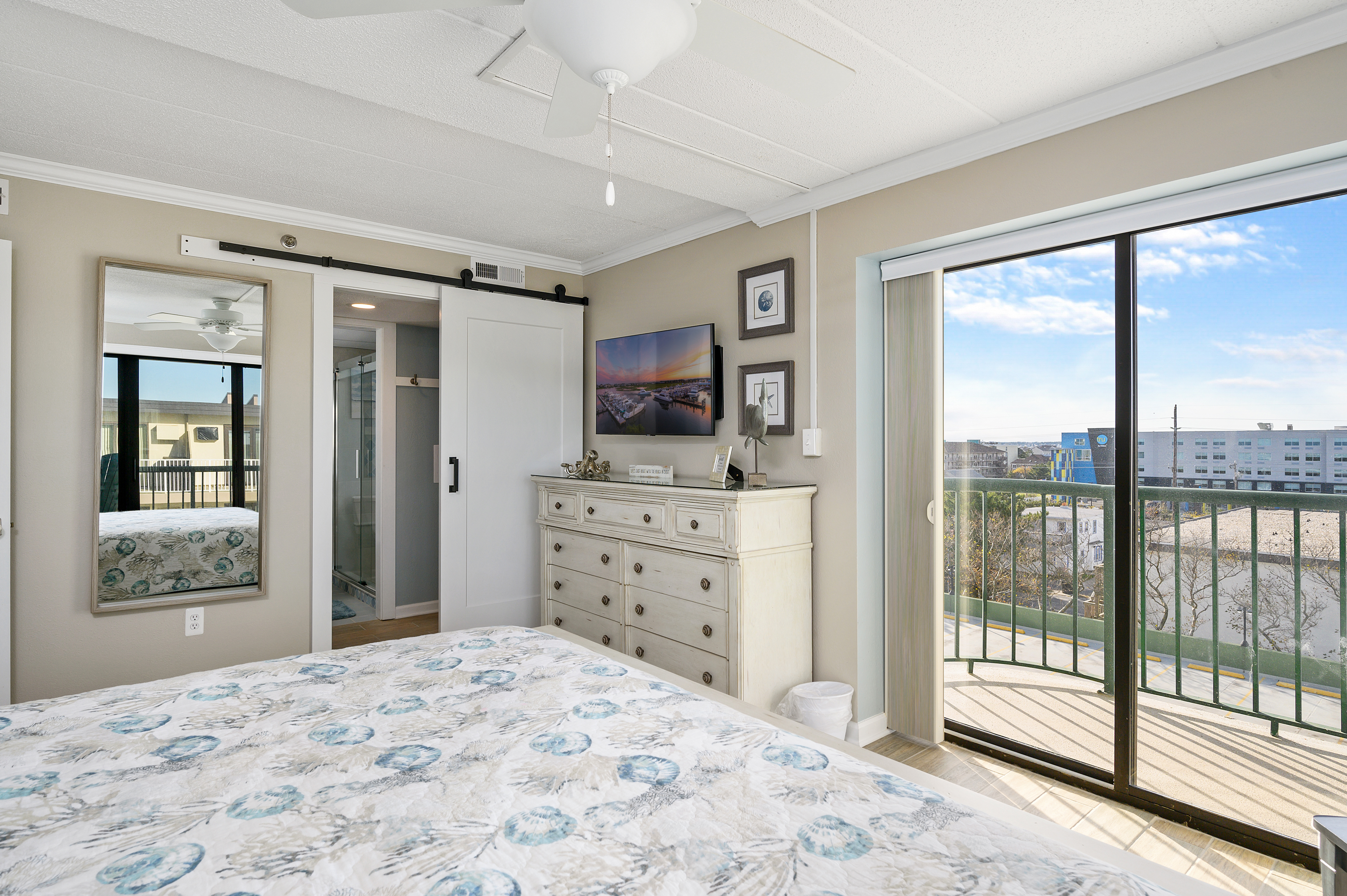 The Flat Screen TV and Barn Door are just a couple of the wonderful touches in Bedroom 1