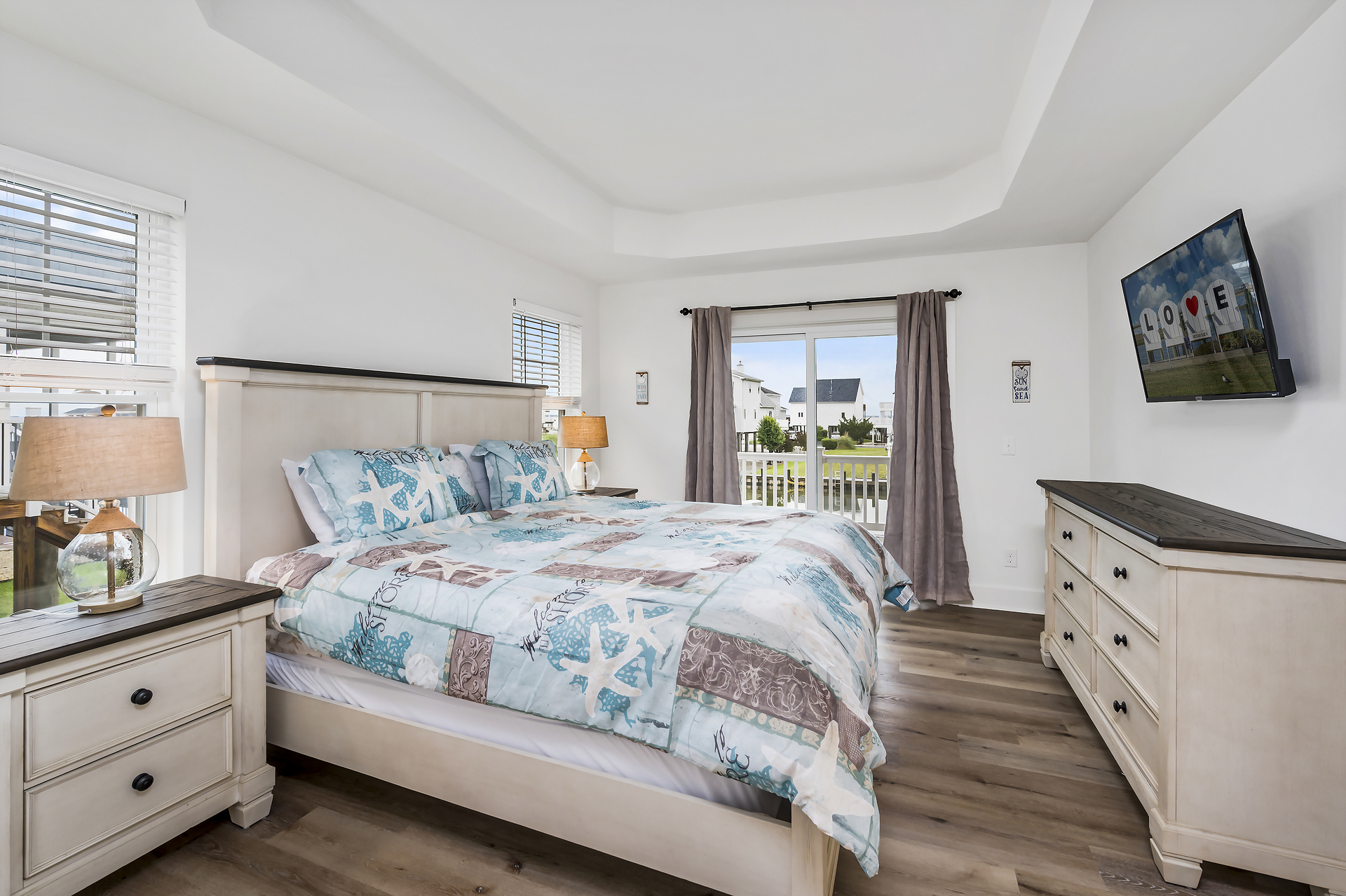 Master Bedroom with comfy King Bed and access to Waterfront Deck.