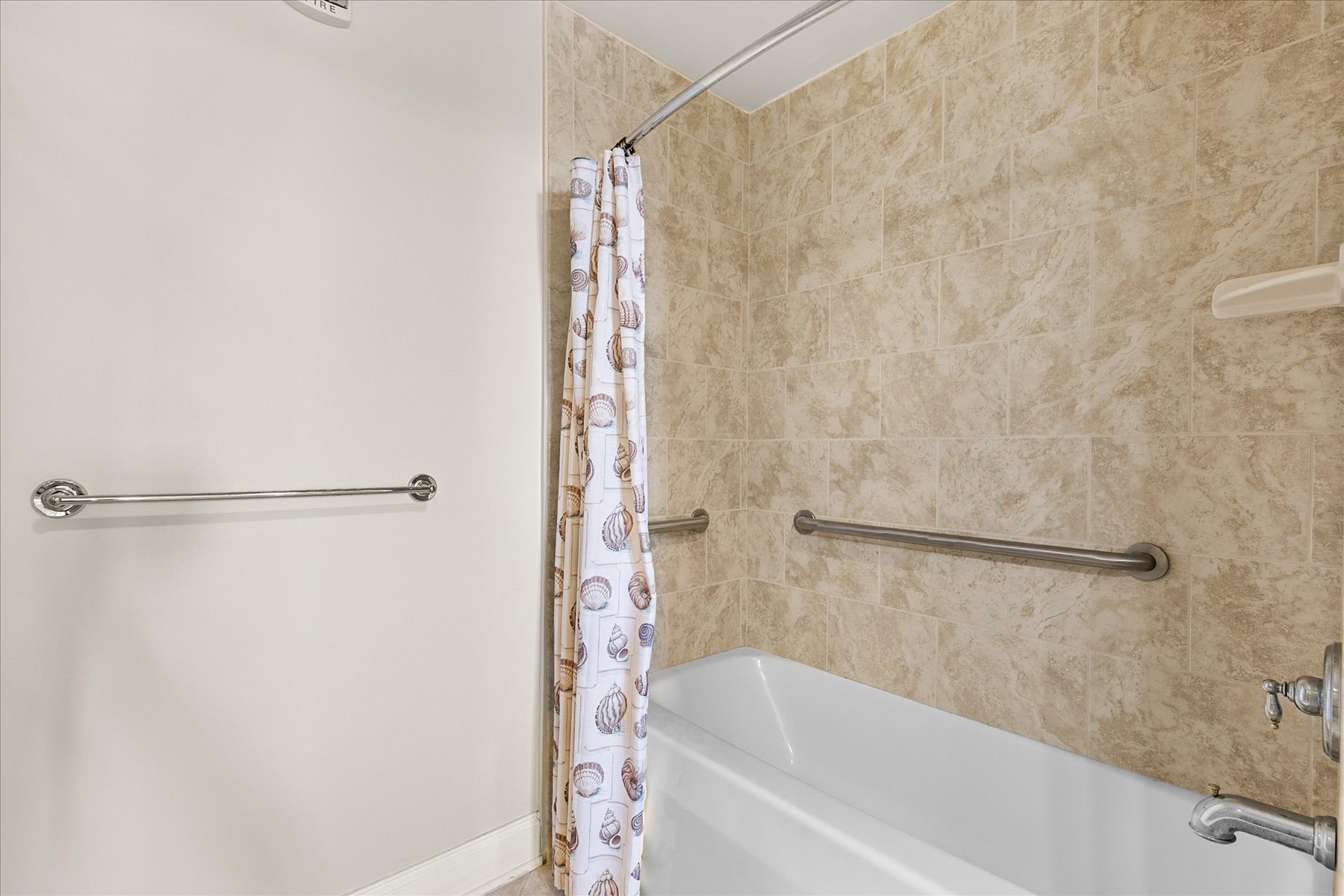 The Shower/Tub Combo in the Primary bath is also equipped with handrails