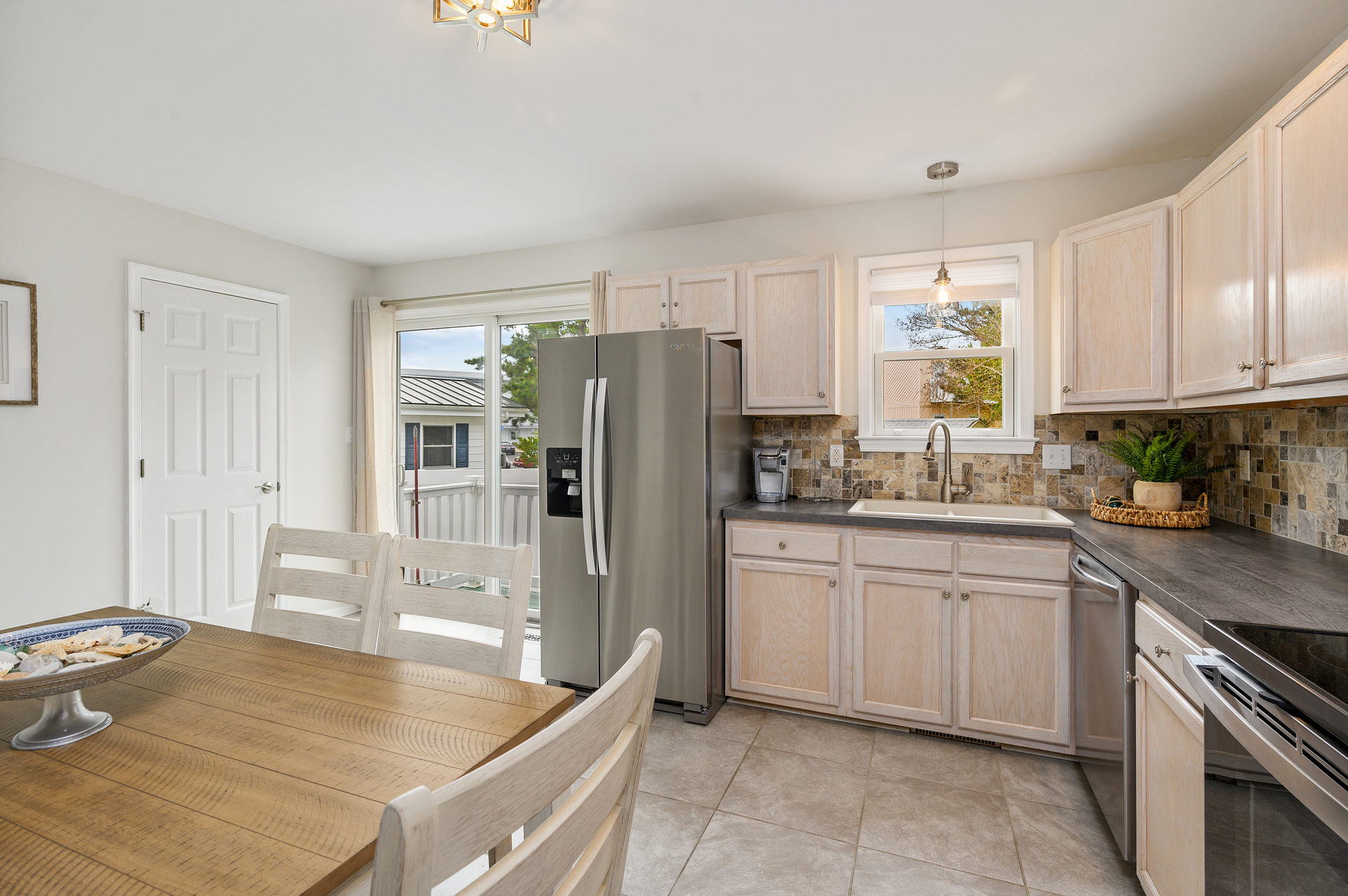 Driftwood's kitchen has an entrance to the fenced in patio