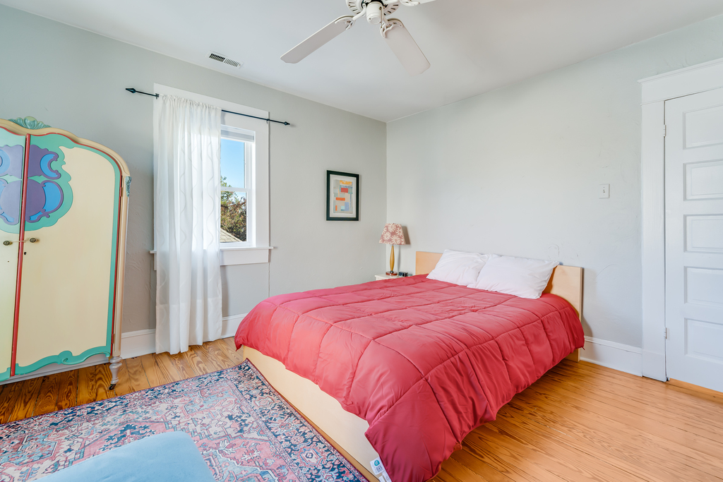 Down the hall, Bedroom 2 has a Queen Bed and bright pops of color.