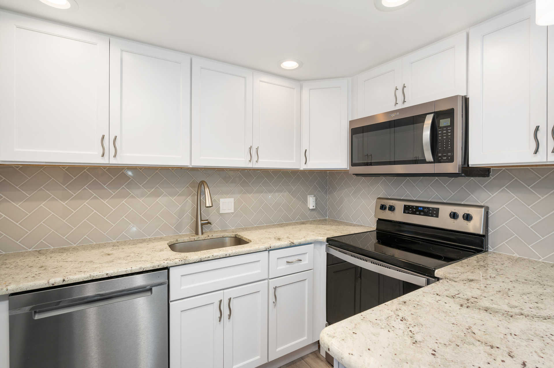 Stainless Steel Appliances and Glossy Granite Countertops throughout.