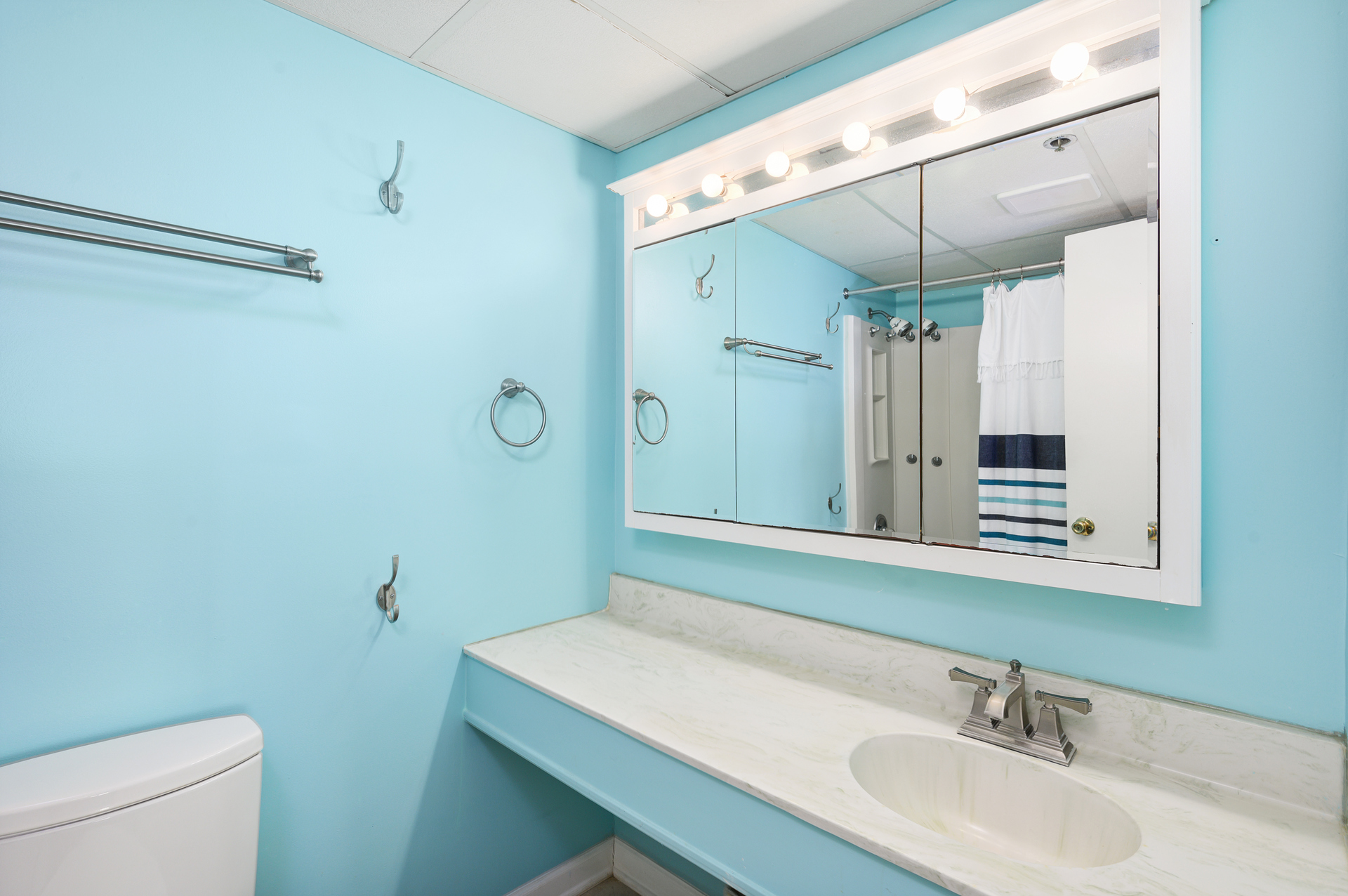 The Primary Bath has soothing blue hues to compliment the beautiful marble counters.