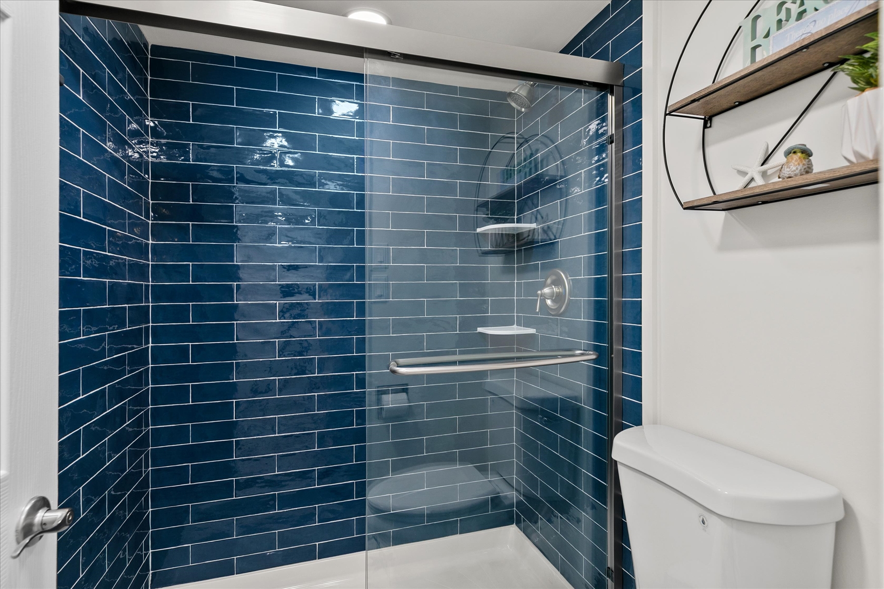 Wash away the sand in the stunning, custom tiled walk-in shower.