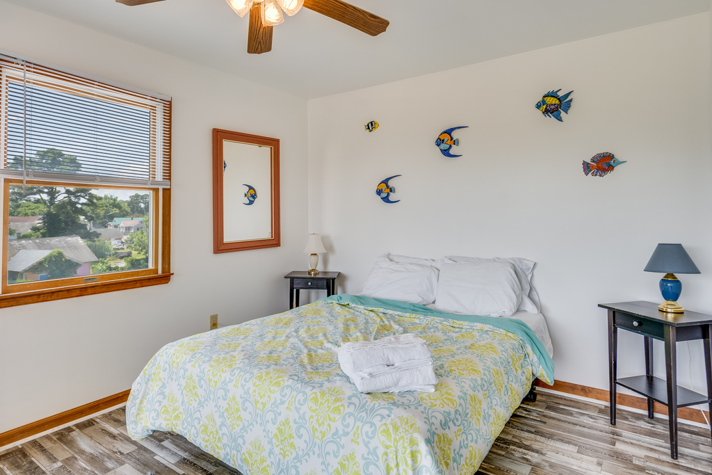 Bedroom 1 has a comfy Queen Bed & Access to Private Water View Balcony.