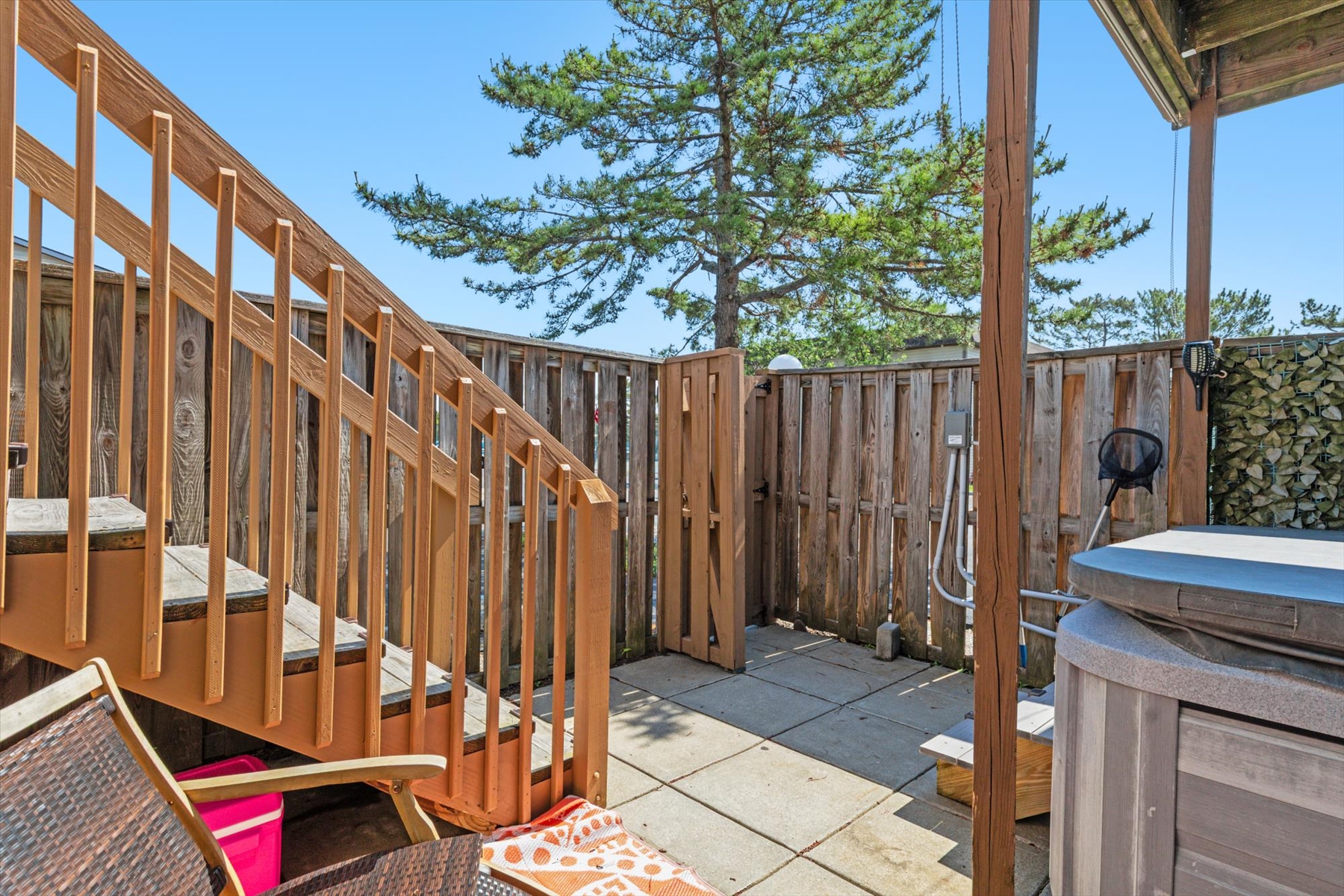 The private, fenced-in backyard patio area ensures peace and quiet during your outdoor vacation downtime.