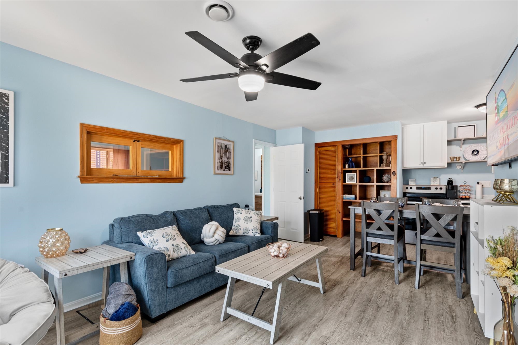 An alternative look at the open-concept design, highlighting the ample seating and warm wood decor accents.