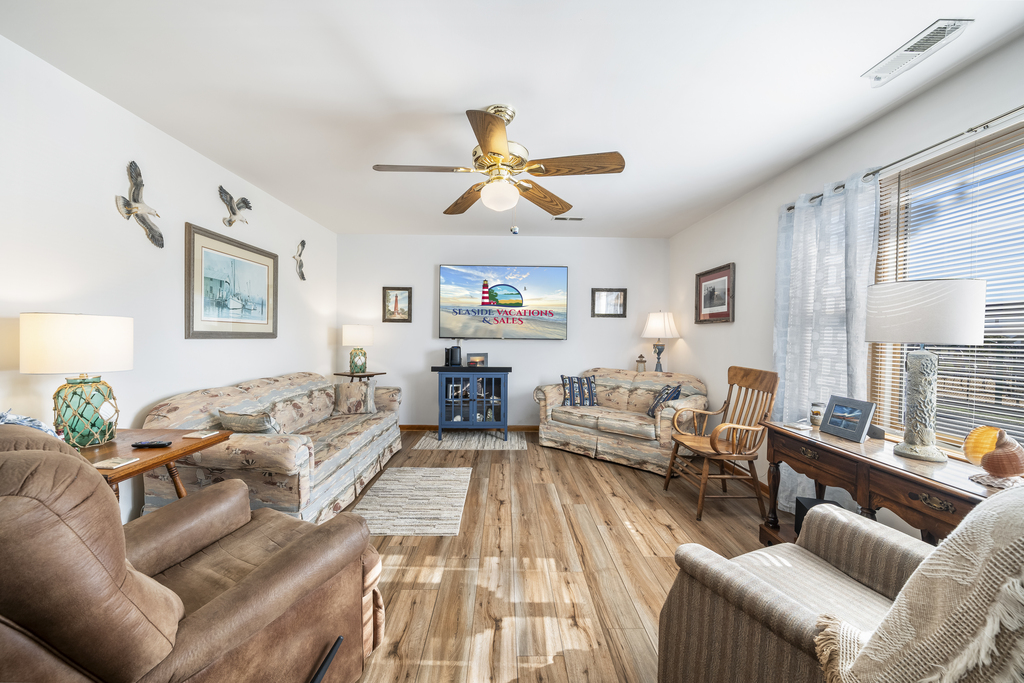 Cozy Living Area with comfy Furnishings and 70 inch Flat Screen Smart TV.