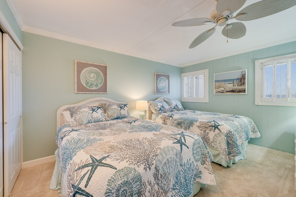 The bedroom includes 2 plush Queen Beds.