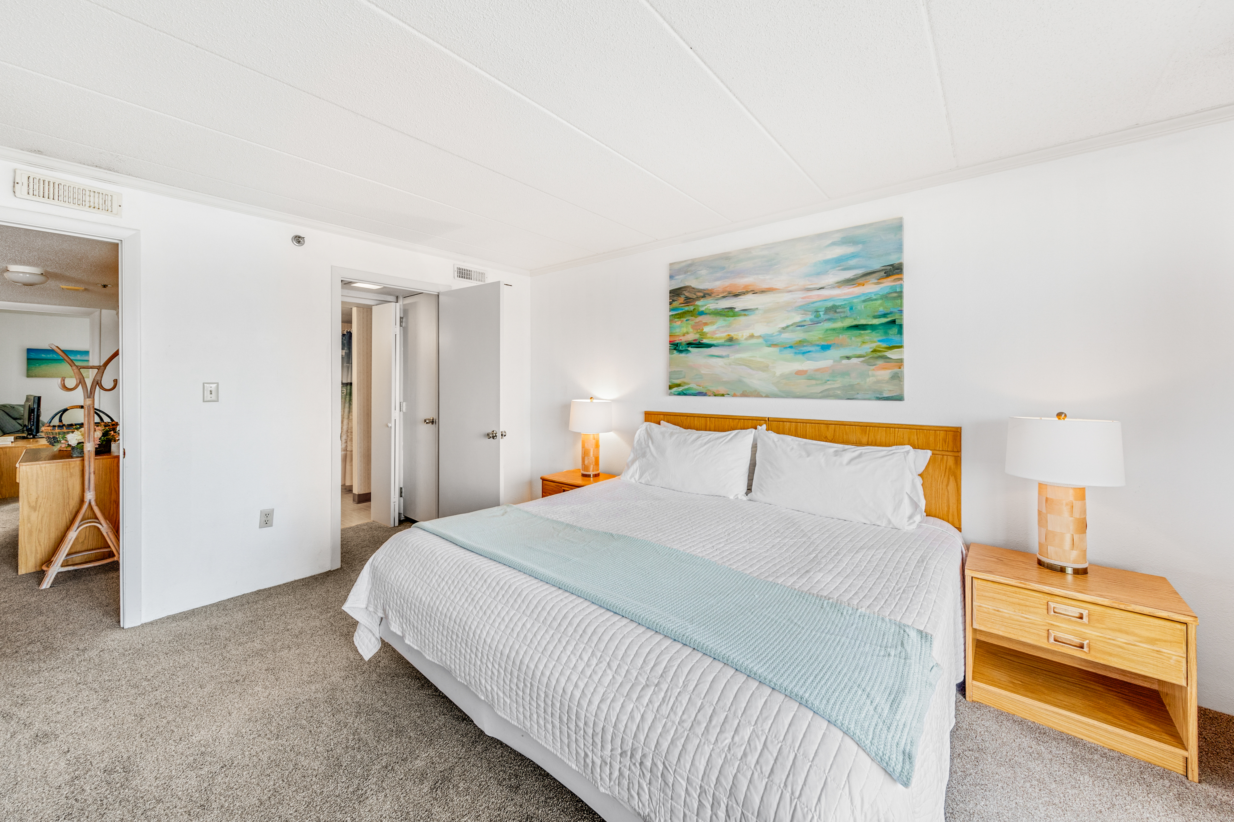 Primary bedroom features a king size bed that you won't be able wait to crawl into after a long day at the beach.