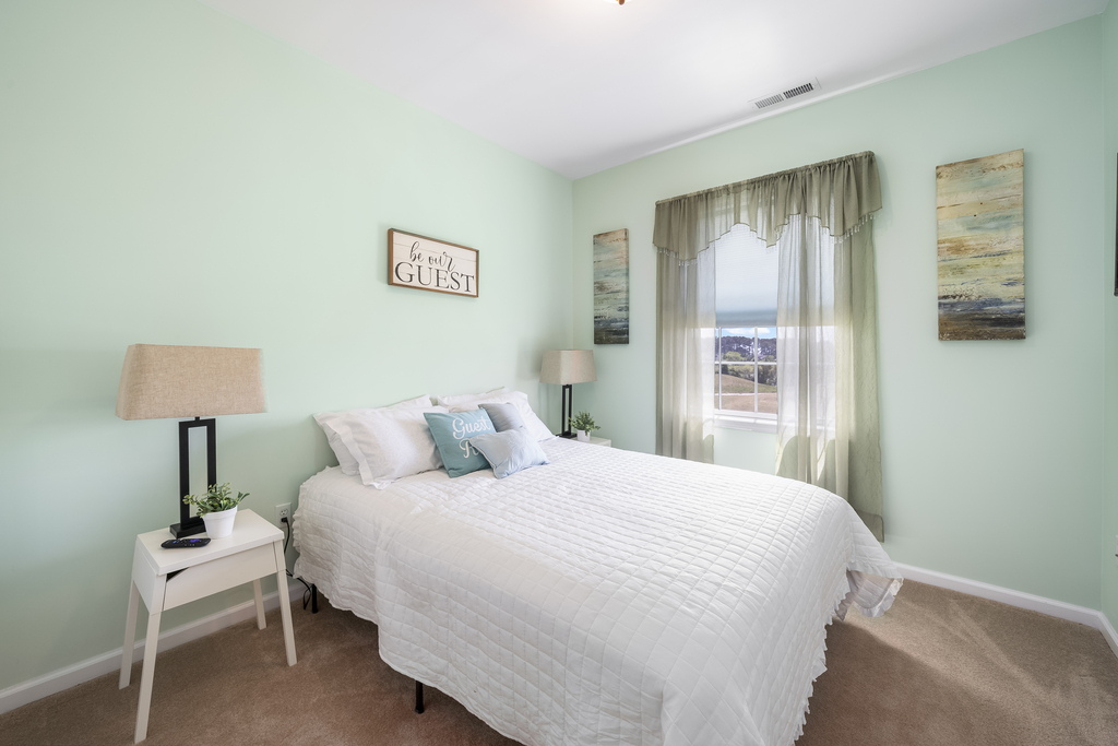 Upstairs, Bedroom 2 has a Queen Bed and crisp white bedding.