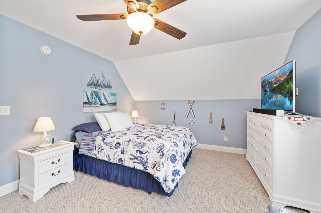 Upstairs, Bedroom 2 has a comfy Queen Bed and is decked out in nautical navy and crisp white.