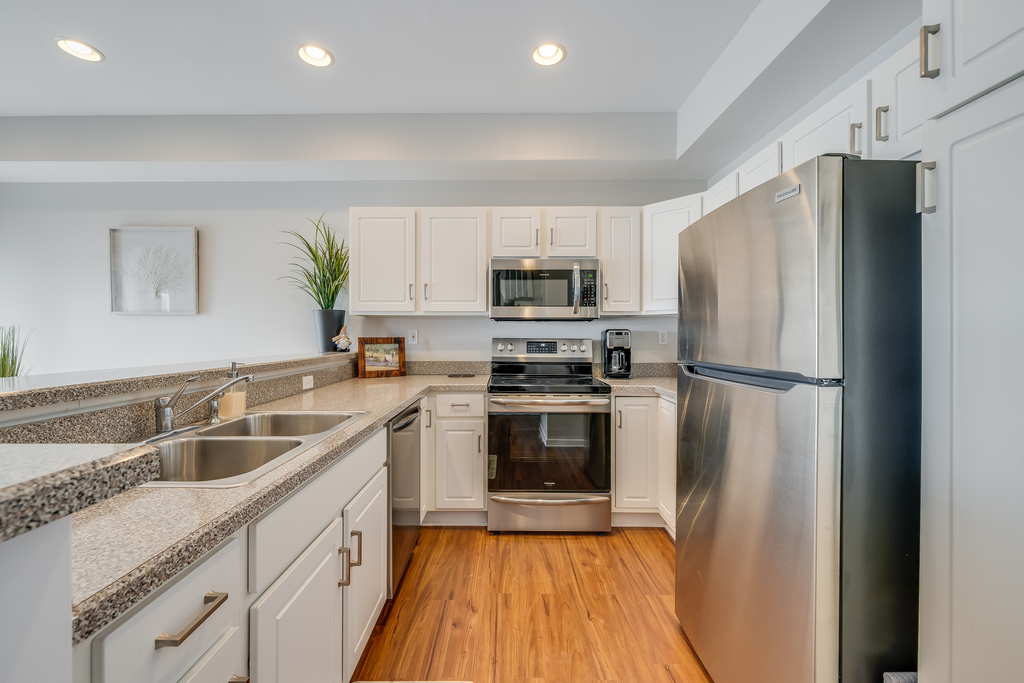 Stainless Appliances and beach White Cabinetry.