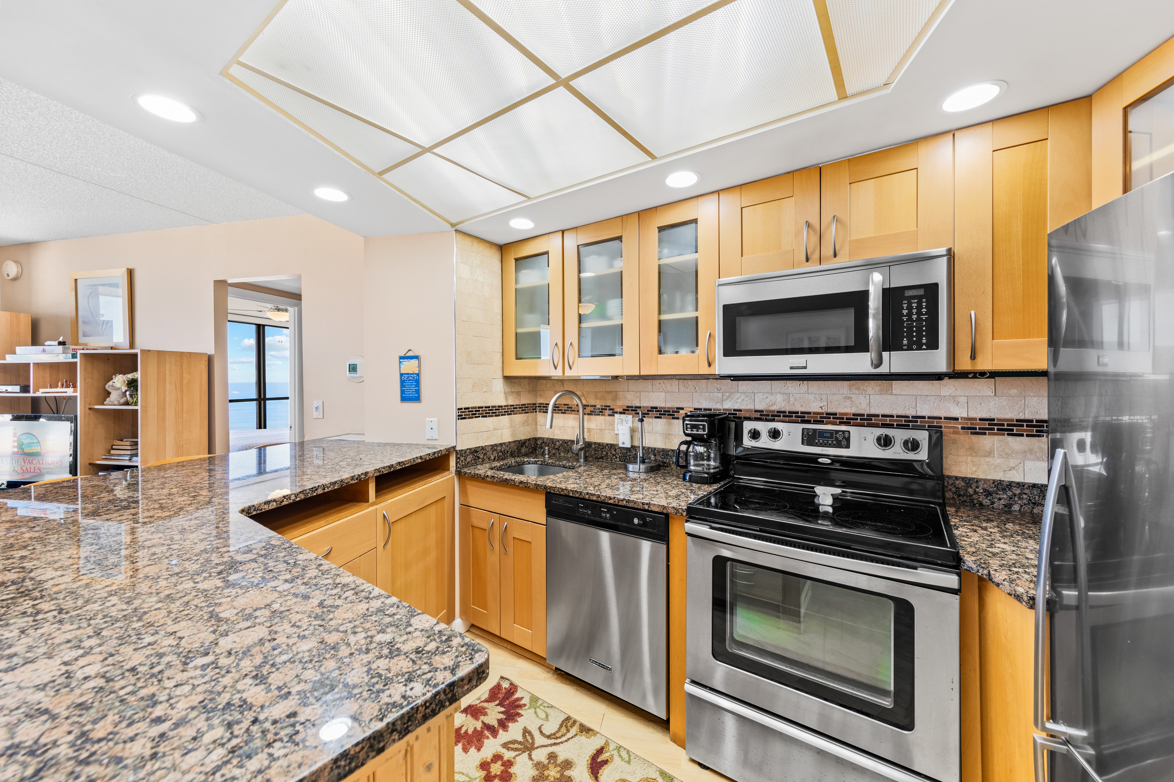 Warm Wood Cabinets & Gleaming Granite are quite luxurious.