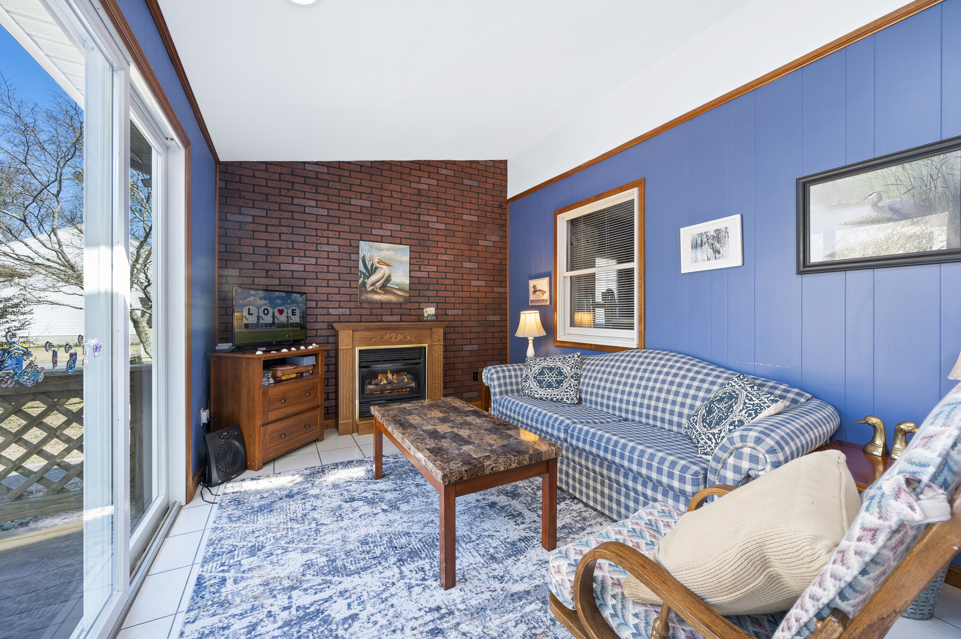 Sunroom lines the back of the home and overlooks the Private Pool.
