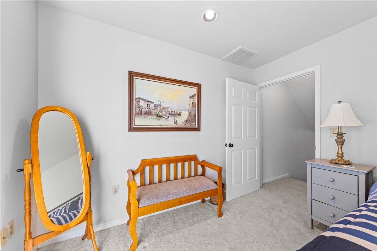 This spacious Bedroom is decked out in Nautical Navy and Crisp Whites.