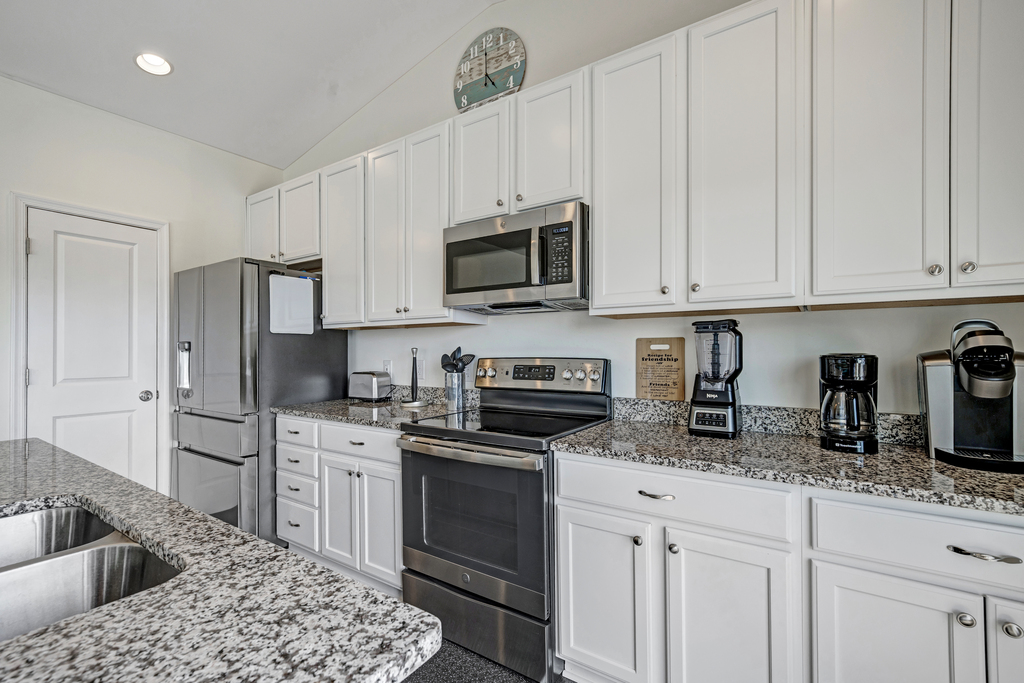 Beachy White Cabinetry, Stainless Appliances, and Granite Countertops.