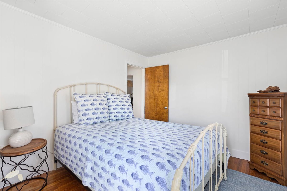 Bedroom 1 has a Queen Bed and is dressed in beachy blues.