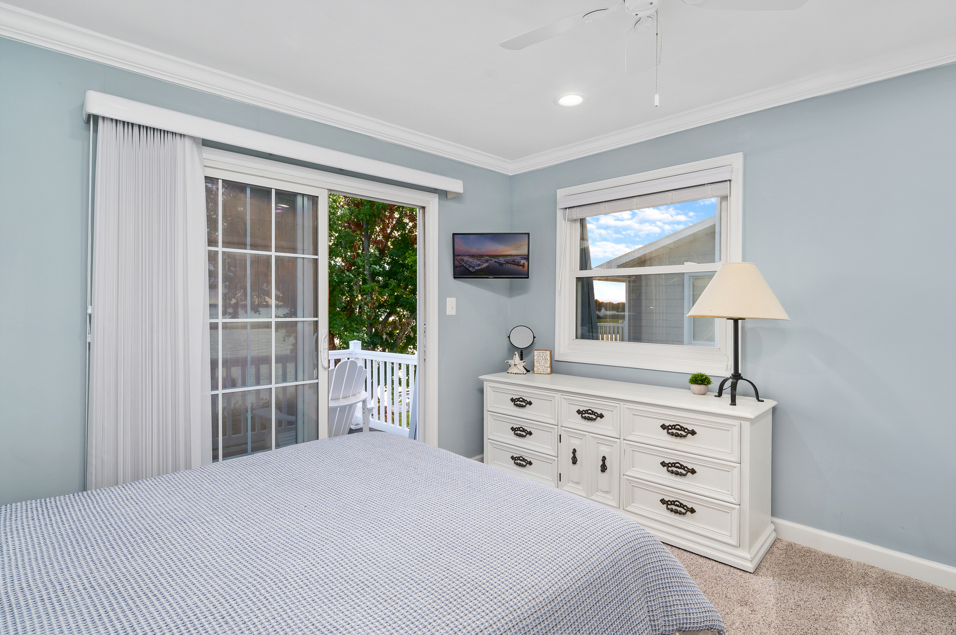 Bedroom 1 has a plush Queen bed and flat screen TV.