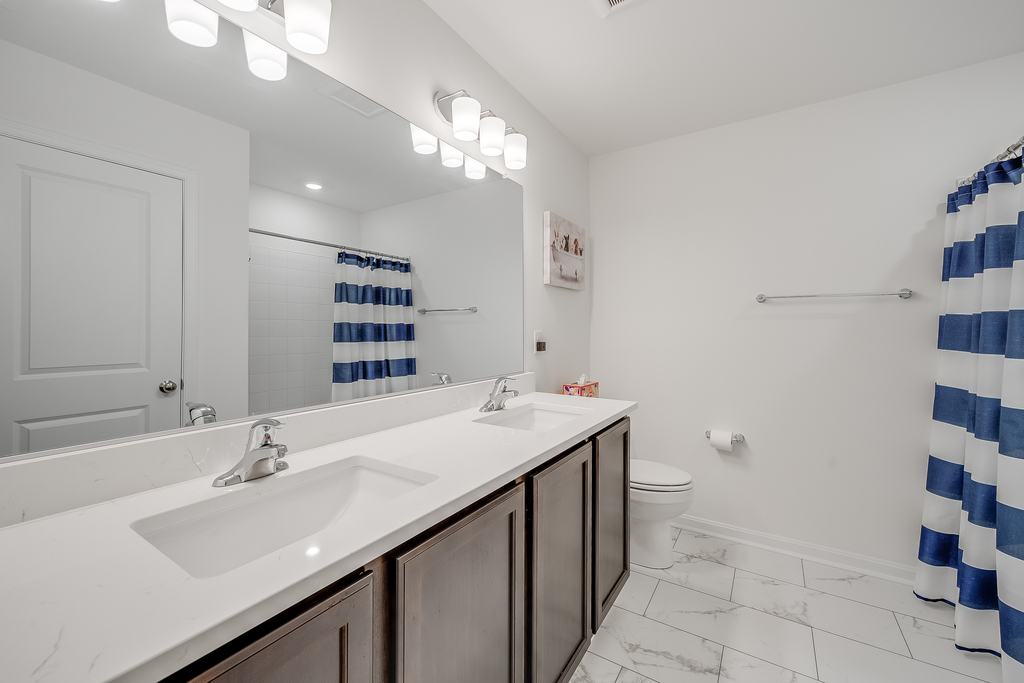 Primary Bedroom has an Attached Full Bath with Tub/Shower Combo and Double Vanity.