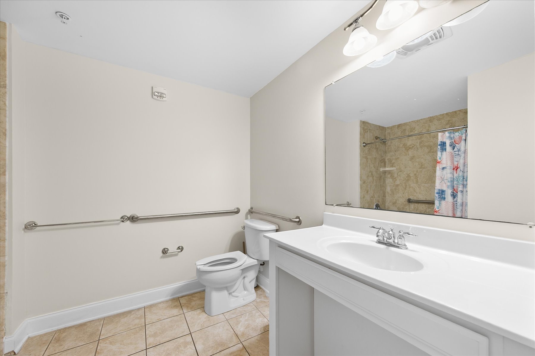The Shared full bath is handicap friendly with handrails for toilet and the Shower/Tub