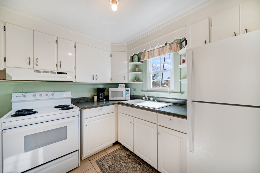 Beach white cabinetry and cool coastal colors team up with historic Chincoteague charm.