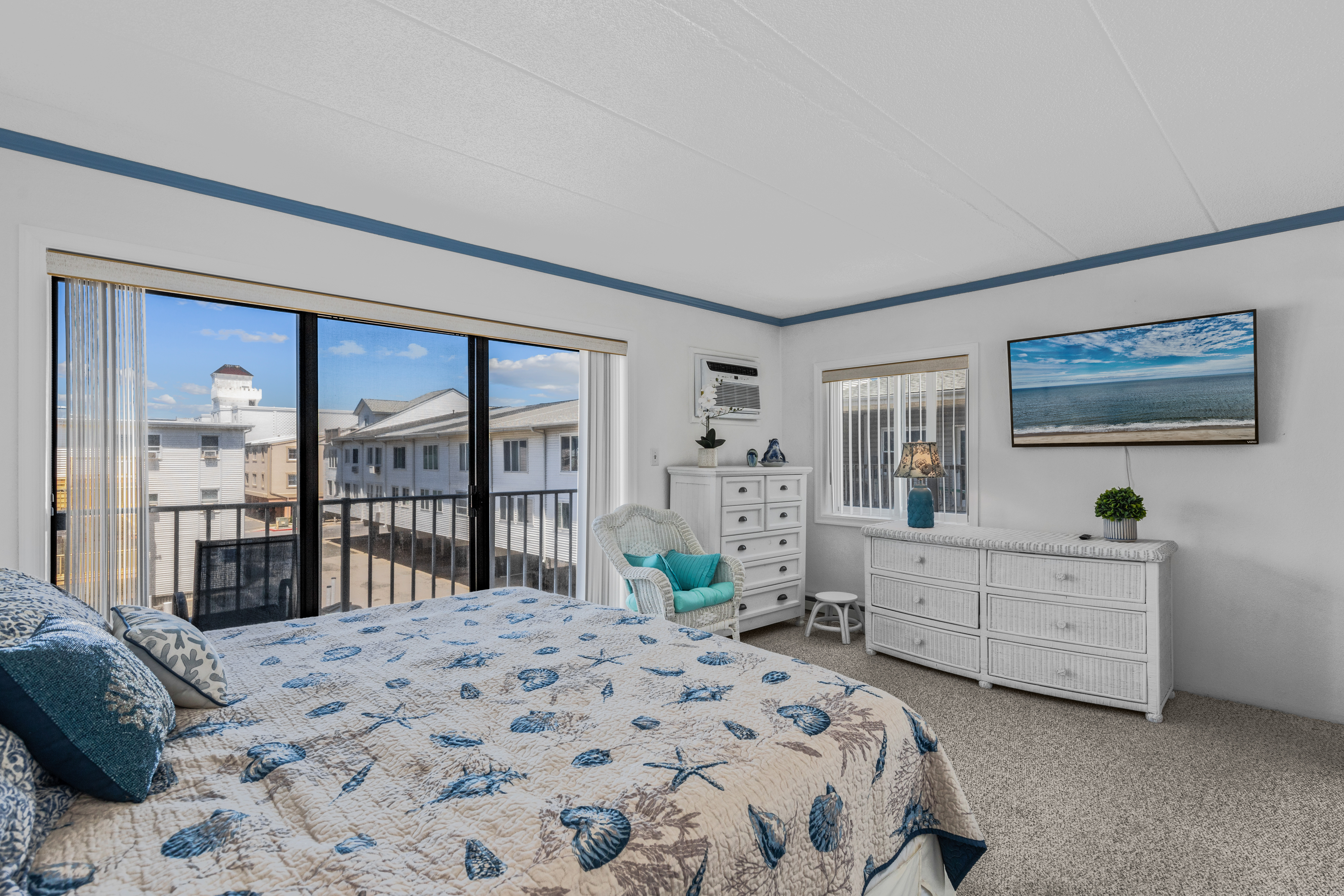 The Primary Bedroom has calming decor, is flooded with natural light from the large sliding door, helping to start each day feeling relaxed and refreshed.