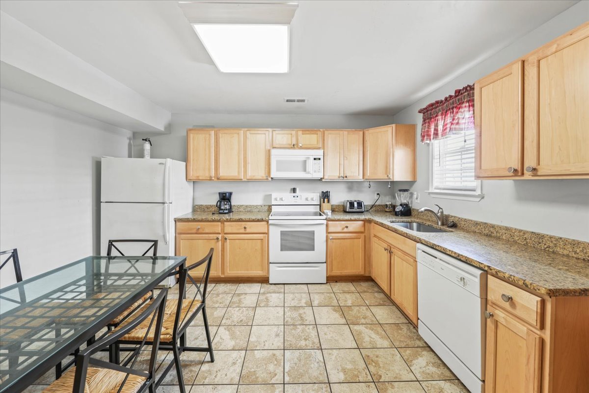 Warm wood cabinets & tons of countertop space in the spacious Kitchen.