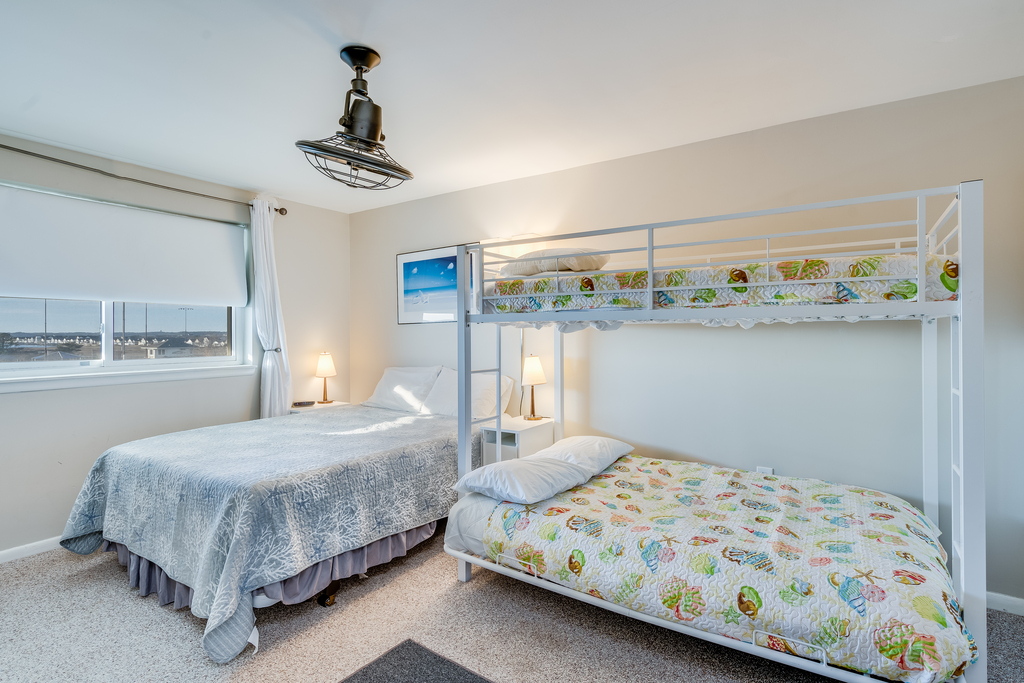 The bedroom comfortably sleeps 4 with a cozy queen bed and pyramid bunk bed (twin over full)
