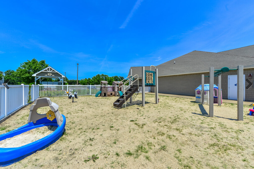 Kids will love this playground with slides, climbing equipment and sandbox fun under bright blue skies.